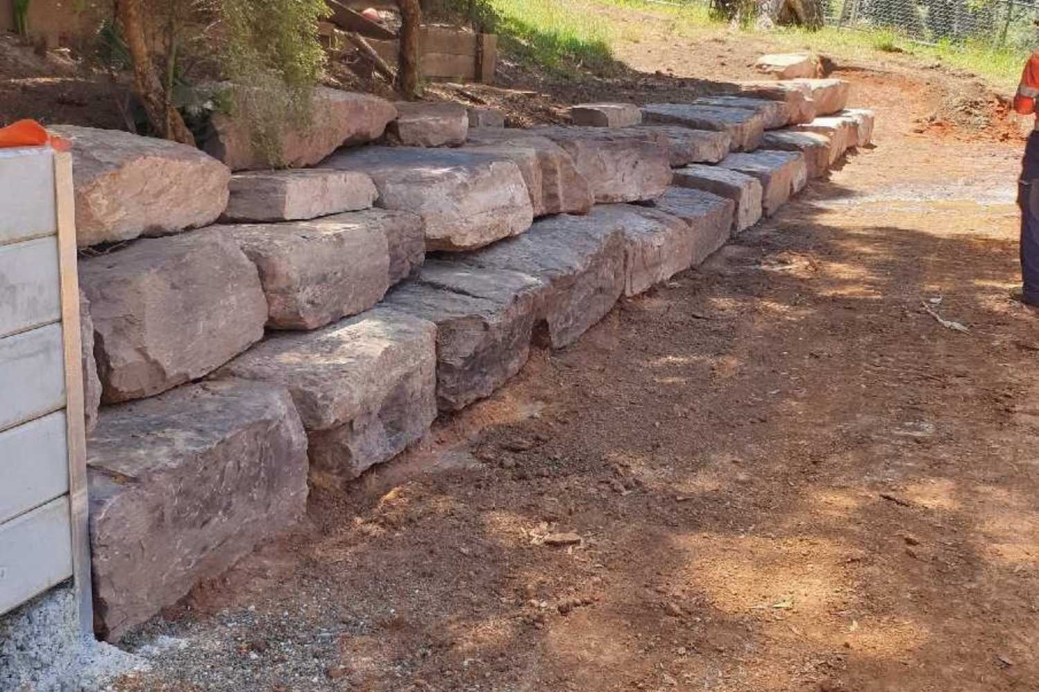 Benefits and Drawbacks of Boulder Retaining Walls - Hammer Excavations