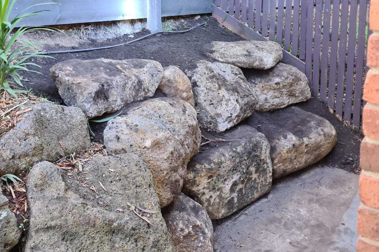 Benefits and Drawbacks of Rock Retaining Walls - Hammer Excavations