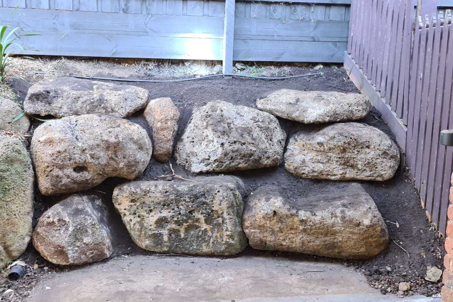 Key Differences Between Boulder and Rock Retaining Walls - Hammer Excavations